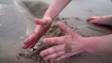 Children on summer vacation making on beach building sand castle together. kids playing with at tropical beach. enjoying playing warm sunny day on seashore. Family, Holiday and Travel concept