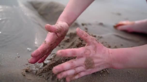 Children on summer vacation making on beach building sand castle together. kids playing with at tropical beach. enjoying playing warm sunny day on seashore. Family, Holiday and Travel concept — ストック動画