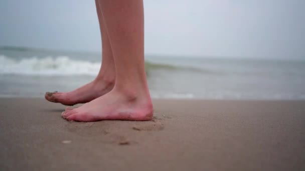 Close up of person bare feet walking at tropical beach. People playing barefoot at tropical beach. Having fun jumping in sea water on warm sunny day on seashore. Summer travel and vacation concept — 비디오