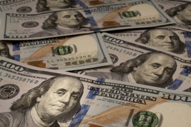 One Hundred Dollar bills with Benjamin Franklin highlighted clipart