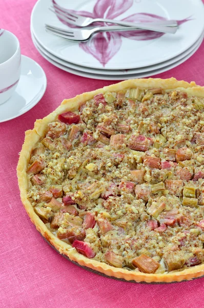 Rhubarb & almond tart on pink table. — Stock Photo, Image