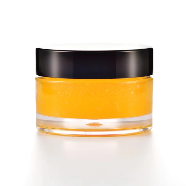 Oranje suiker lip scrub op wit. — Stockfoto