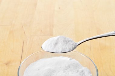 Close-up of baking soda on spoon. clipart