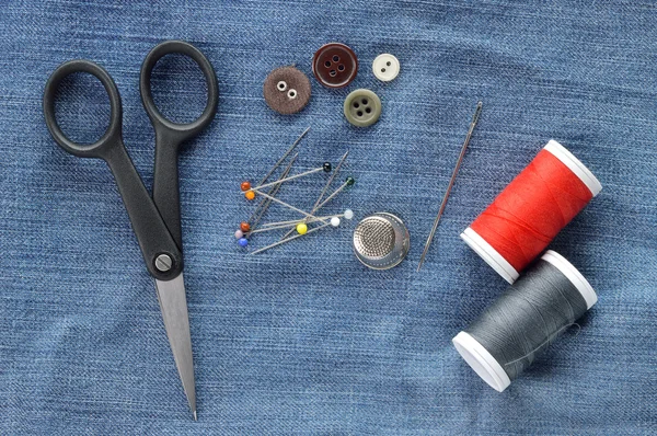 Sewing kit on jeans background. — Stock Photo, Image