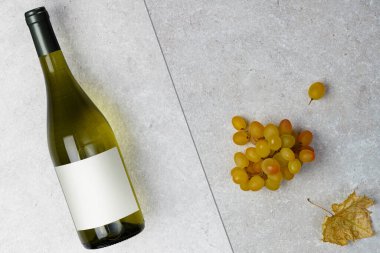 Bottle of white wine with label.  Wine and grape. Wine bottle mockup. Top view.	
