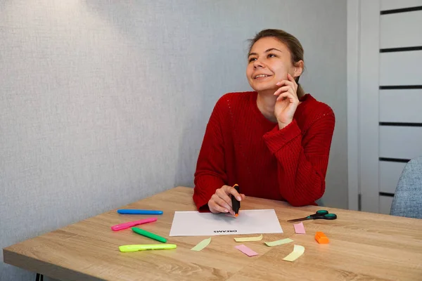 Portrait of young beautiful thoughtful lady writing down her dreams list — Stock Photo, Image