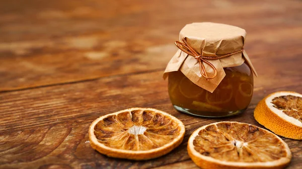 Jar of orange jam on wooden background from top view. Homemade marmalade — Stock Photo, Image