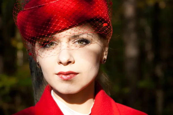 Young woman in red hat and red coat — Stock Photo, Image