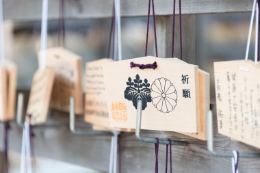 TOKYO, JAPAN - APRIL 10 2014: Wooden prayer tablets at a Meiji Shrine(Meiji Jingu). Pray for happiness ,good life ,healthy ,peace ,luck by write praying word in wooden tablet. clipart