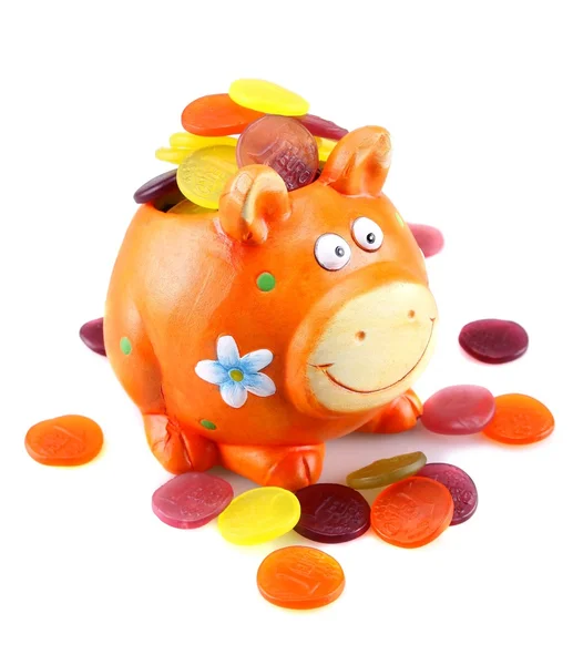 Orange piggy bank with colorful money — Stock Photo, Image