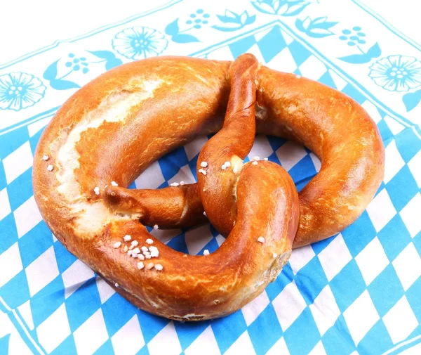 Appetizing pretzel on blue and white pattern — Stock Photo, Image