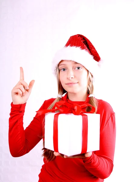 Blond girl as Mrs. Santa gives a present — Stock Photo, Image