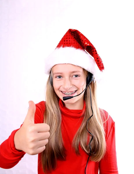 Blond meisje als mrs. santa met een headset doen ok — Stockfoto