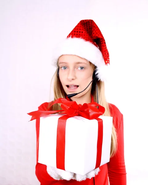 Mrs. Santa speaks with headset and give a gift — Stock Photo, Image