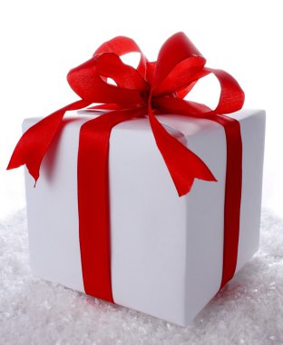 Great gift box with red bow on snow clipart