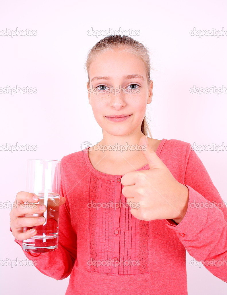 Blonde girl in pink drinks water with ok