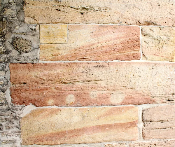 Old wall from a red-yellow rock as background — Stock Photo, Image