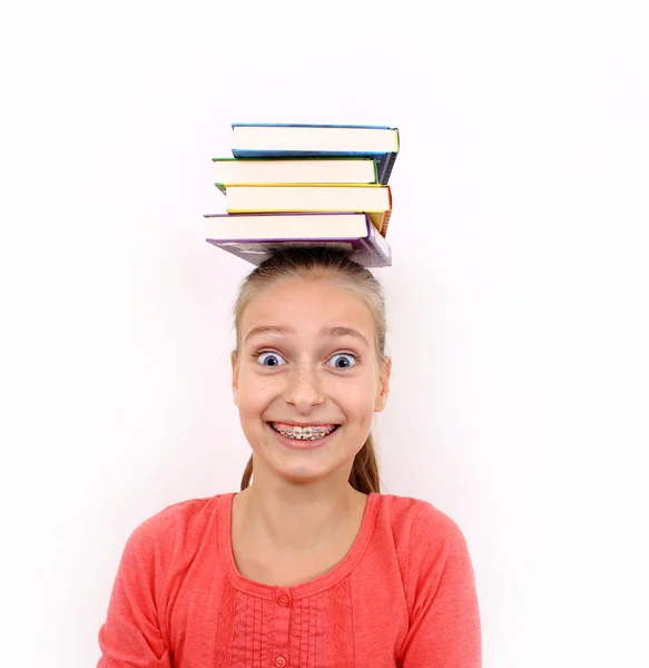 Enthusiastic girl with four books on head — Stock Photo, Image