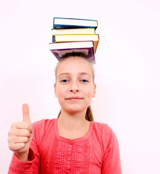 Contented girl with OK sign and books on head — Stock Photo, Image