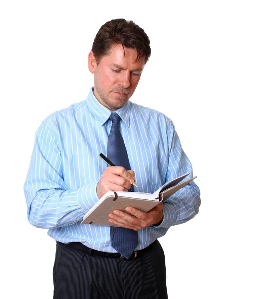 Employee writes notes in notebook Stock Image