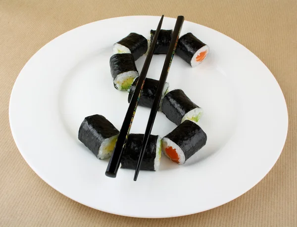 Sushi as dollar sign on white plate — Stock Photo, Image