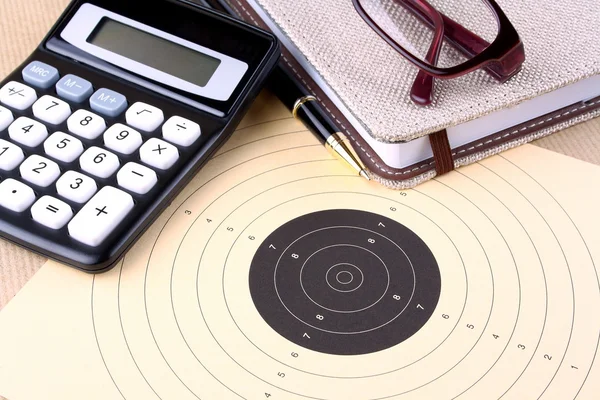 Target, calculator, pen, notebook, glasses - setting goals — Stock Photo, Image