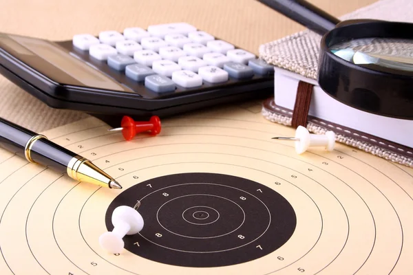 Find the target - magnifying glass, calculator, pen, pins — Stock Photo, Image