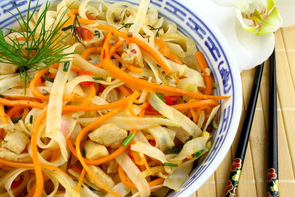 Rice noodle with chicken meat, chopsticks with orchid