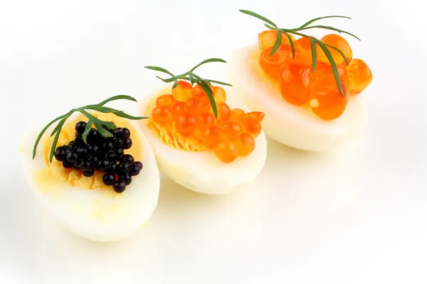 Salmon, trout and sturgeon caviar served on quail eggs — Stock Photo, Image