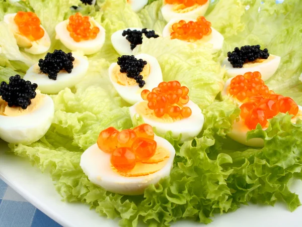 Quail eggs topped with salmon, trout and sturgeon caviar — Stock Photo, Image