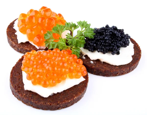 Black bread topped with salmon, trout and sturgeon caviar — Stock Photo, Image