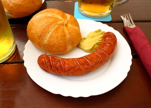 Sausage with bread on the table in beer garden — Stock Photo, Image