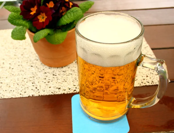 Liter of beer at the table in beer garden — Stock Photo, Image