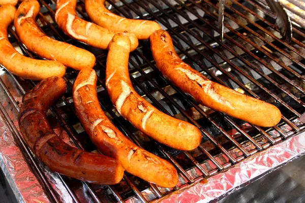 Delicious german sausages on grill — Stock Photo, Image