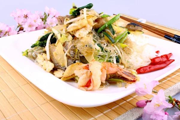 Glass noodles with rice, meat, vegetables and flowers — Stock Photo, Image