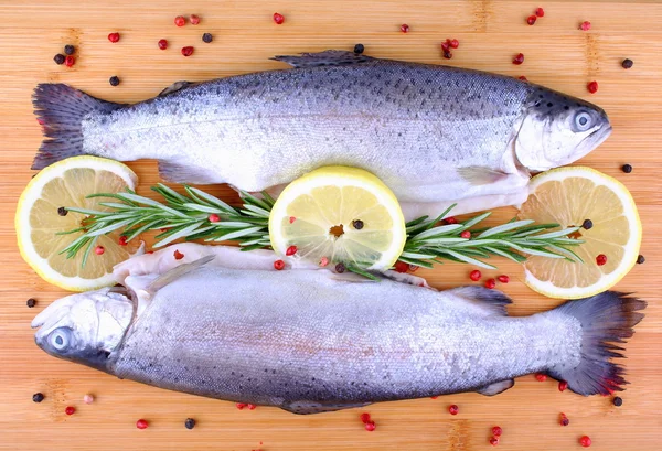 Two fresh full trout with species on bamboo board — Stock Photo, Image