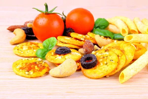 Snack, pizza crackers, dried olives, nuts, tomatoes — Stock Photo, Image