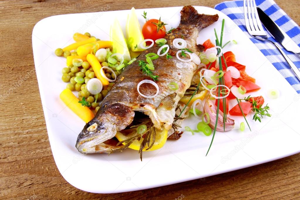 Grilled trout with quite fine vegetables and cutlery