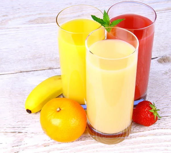 Bananas, strawberry and oranges juice in glass — Stock Photo, Image