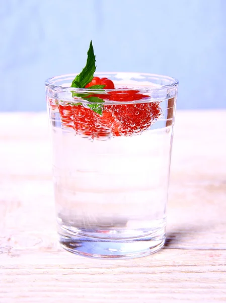 Water in glas met frambozen en mint — Stockfoto