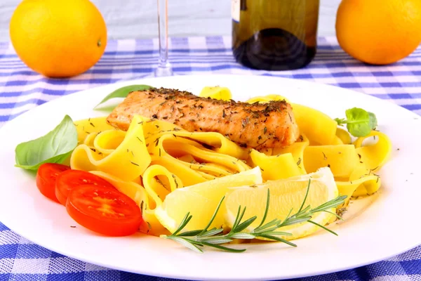 Grilled salmon fillet, taglateli, lemon and herbs — Stock Photo, Image