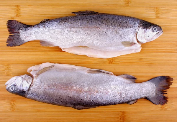 Two fresh whole trout on bamboo board — Stock Photo, Image