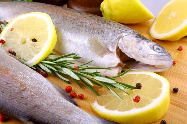 Two whole rainbow trout with spices, red pepper and lemon — Stock Photo, Image