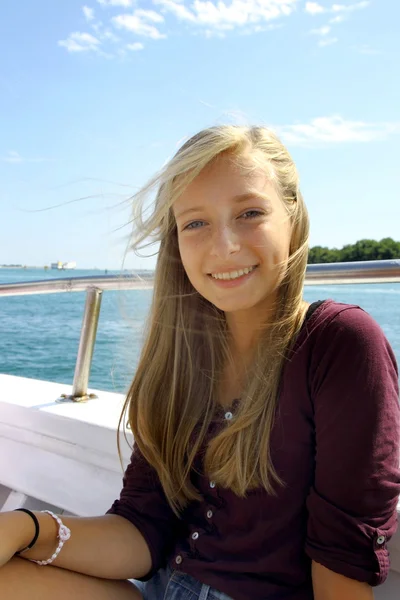 Cheerful young blonde girl on ship at sea — Stock Photo, Image