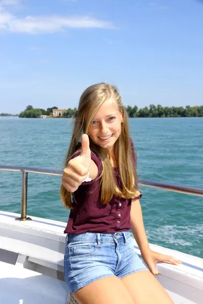 Счастливая молодая блондинка показывает хороший знак на корабле в море — стоковое фото