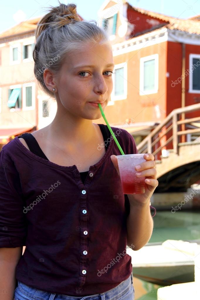 Cute girl with red slush drink