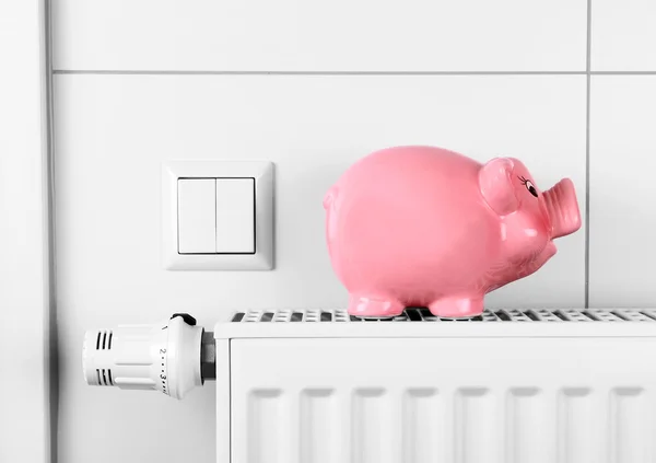 Pink piggy bank saving not electricity and heating costs — Stock Photo, Image