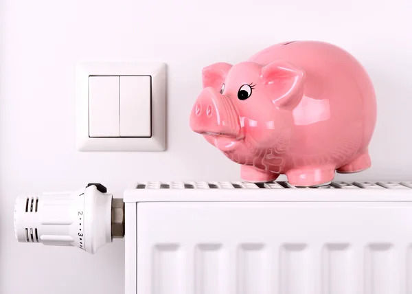 Pink piggy bank jump, saving electricity and heating costs — Stock Photo, Image
