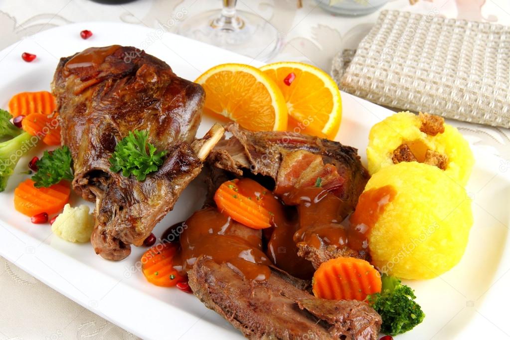 Baked wild rabbit meat with potato dumplings and vegetables
