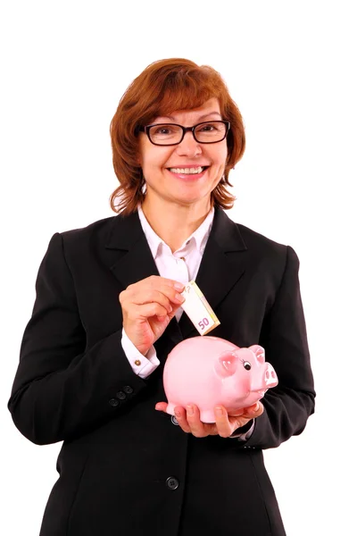 Business woman with piggy bank and fifty euro in hand — Stock Photo, Image